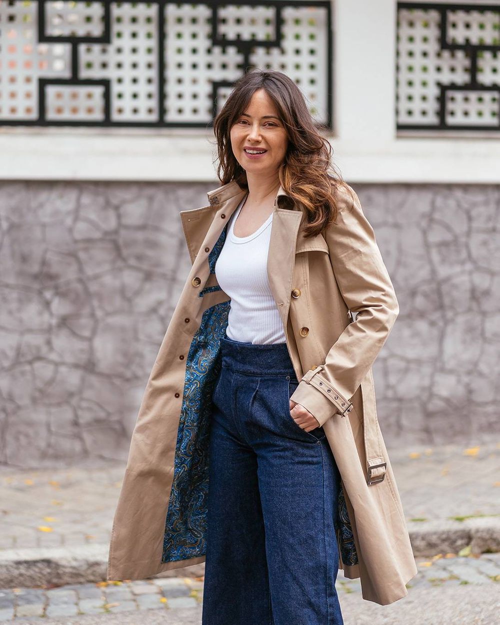 Model wearing a soft neutral trench coat