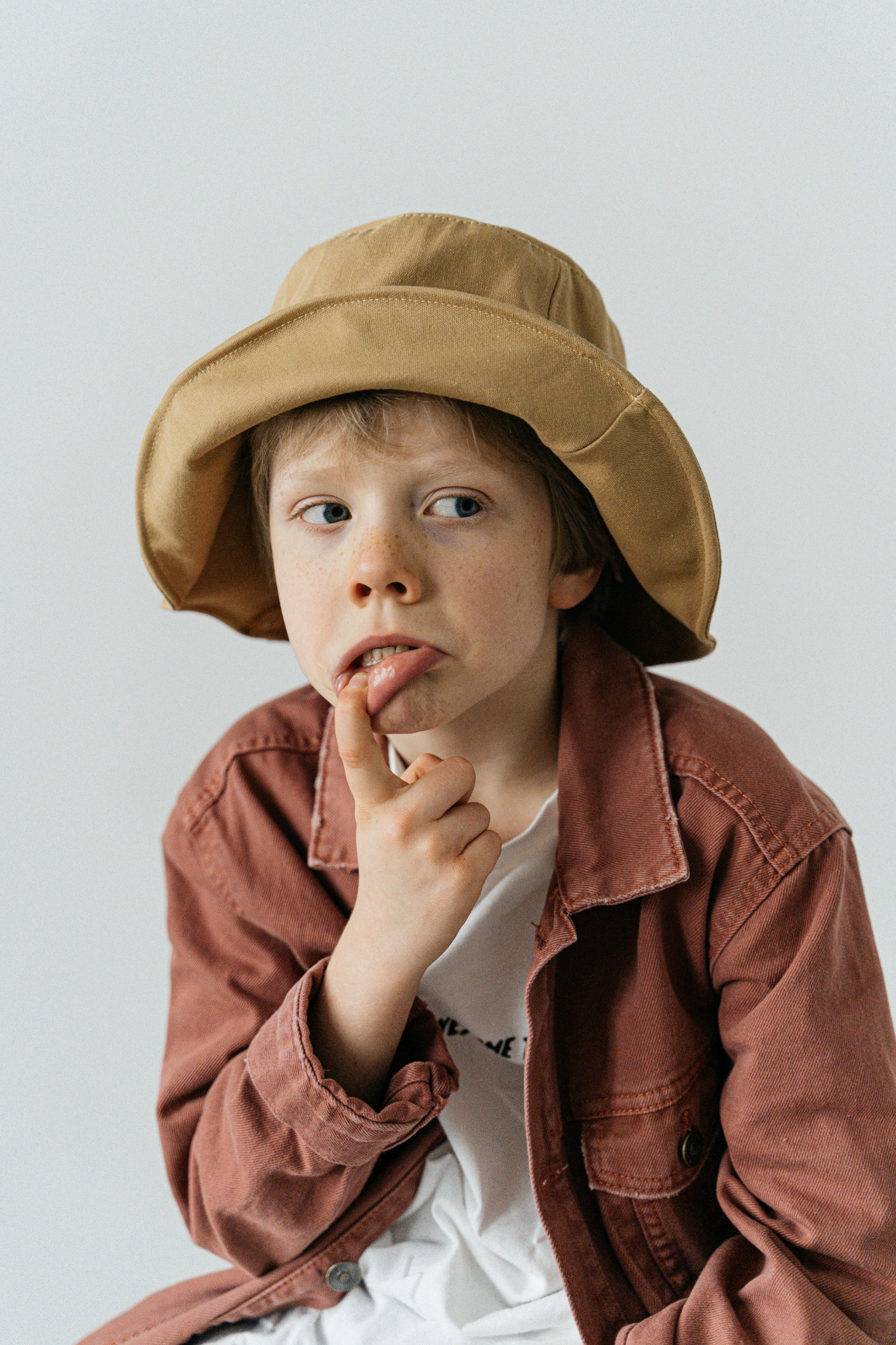 Child wearing a casual jacket and bucket hat